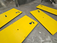 Multiple yellow anti-slip coated RAPTA heavy-duty steel road plates with fixing holes and RAPTA branding