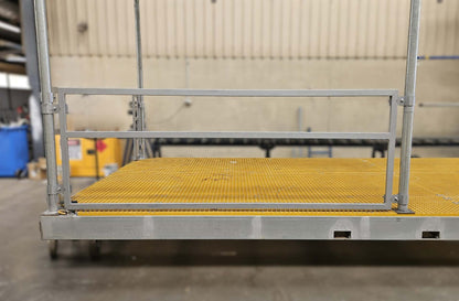 Metal platform with yellow safety surface in a warehouse setting