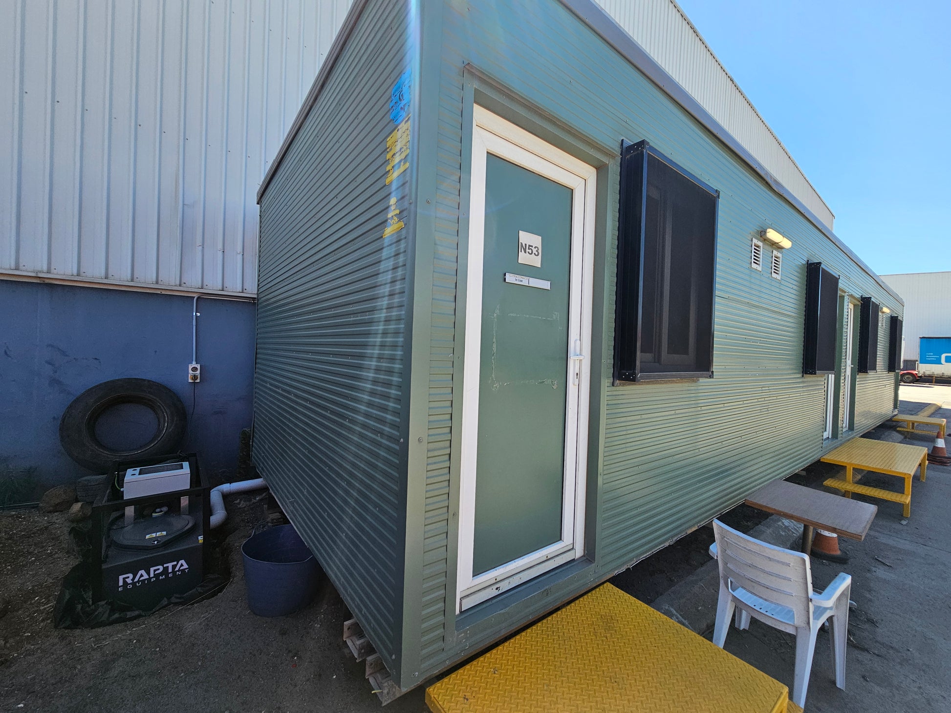 RAPTA CabinPump Ultra wastewater system installed beside a portable site building