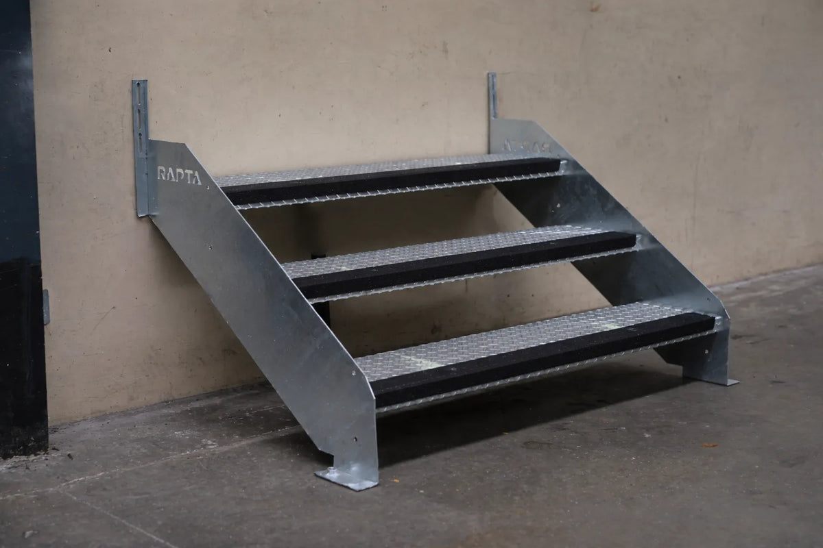 Rapta Heavy Duty Steel Steps with three treads and black non-slip nosing installed against a wall