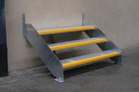Rapta Heavy Duty Steel Steps with three treads installed against a wall - non-slip yellow nosing