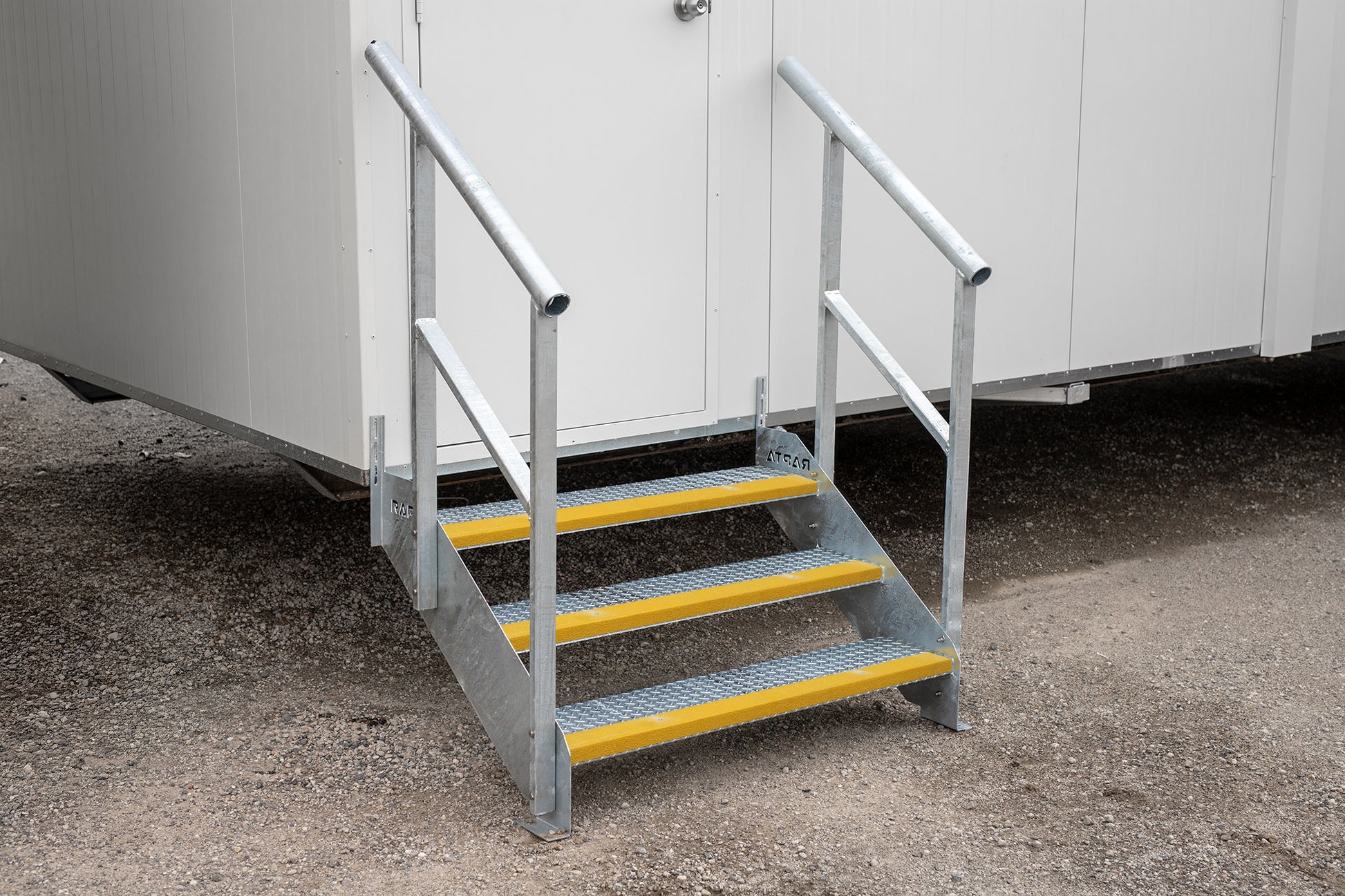 Rapta Heavy Duty Steel Steps with three treads and handrail installed at a modular building entrance