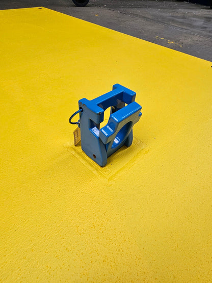 RAPTA Heavy-Duty Road Plate Lifter engaged in the flush-mounted receiver on a yellow steel road plate