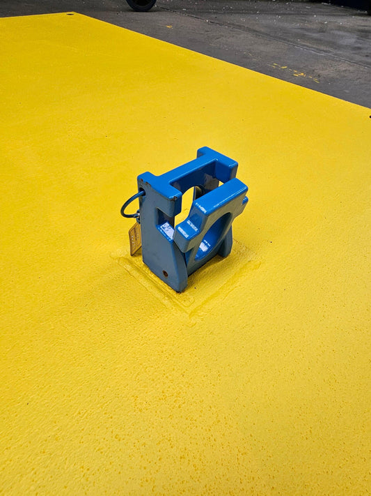 RAPTA Heavy-Duty Road Plate Lifter engaged in the flush-mounted receiver on a yellow steel road plate