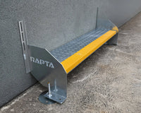 Single Rapta Heavy Duty Steel Step with yellow safety nosing installed against a wall
