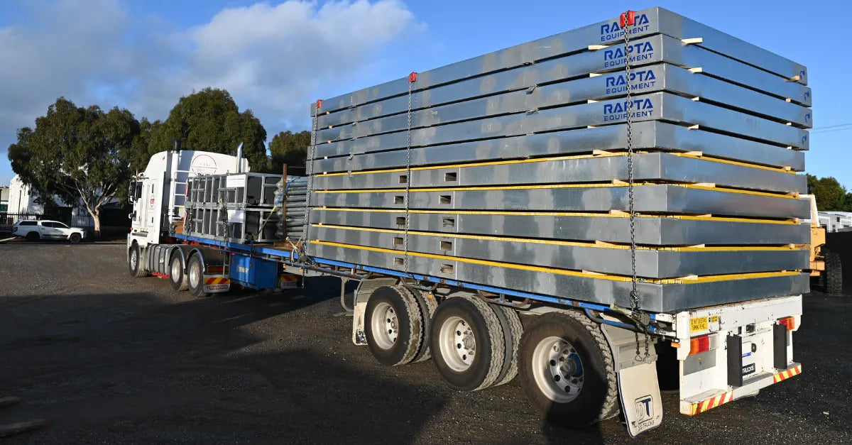 Stacked RaptaCover™ modules secured on a semi-trailer for transport.