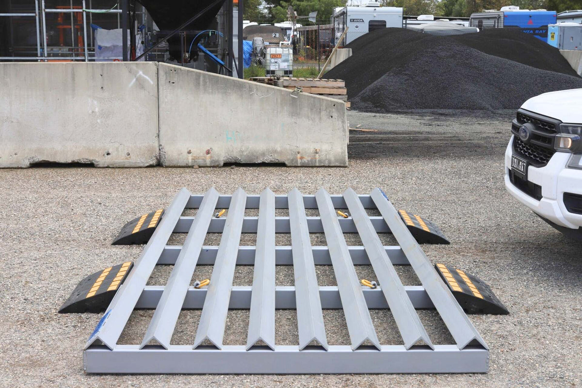 Front view of a RAPTA Rumble Grid with optional heavy-duty ramps installed for vehicle access on a hard surface