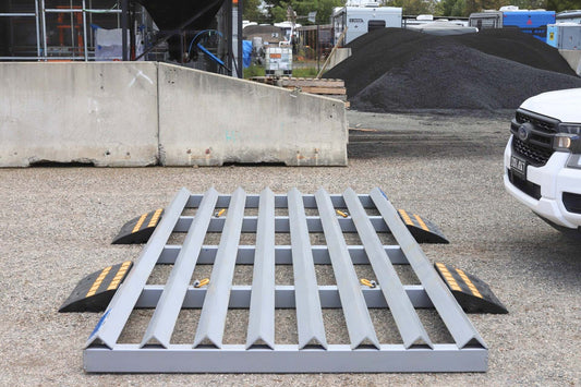 Front view of a RAPTA Rumble Grid with optional heavy-duty ramps installed for vehicle access on a hard surface