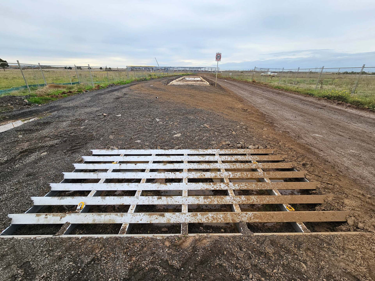 RAPTA Rumble Grid installed in-ground at a construction site access road to remove mud and debris from vehicle tyres