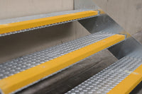 Close-up of Rapta Heavy Duty Steel Steps with three treads and yellow safety nosing