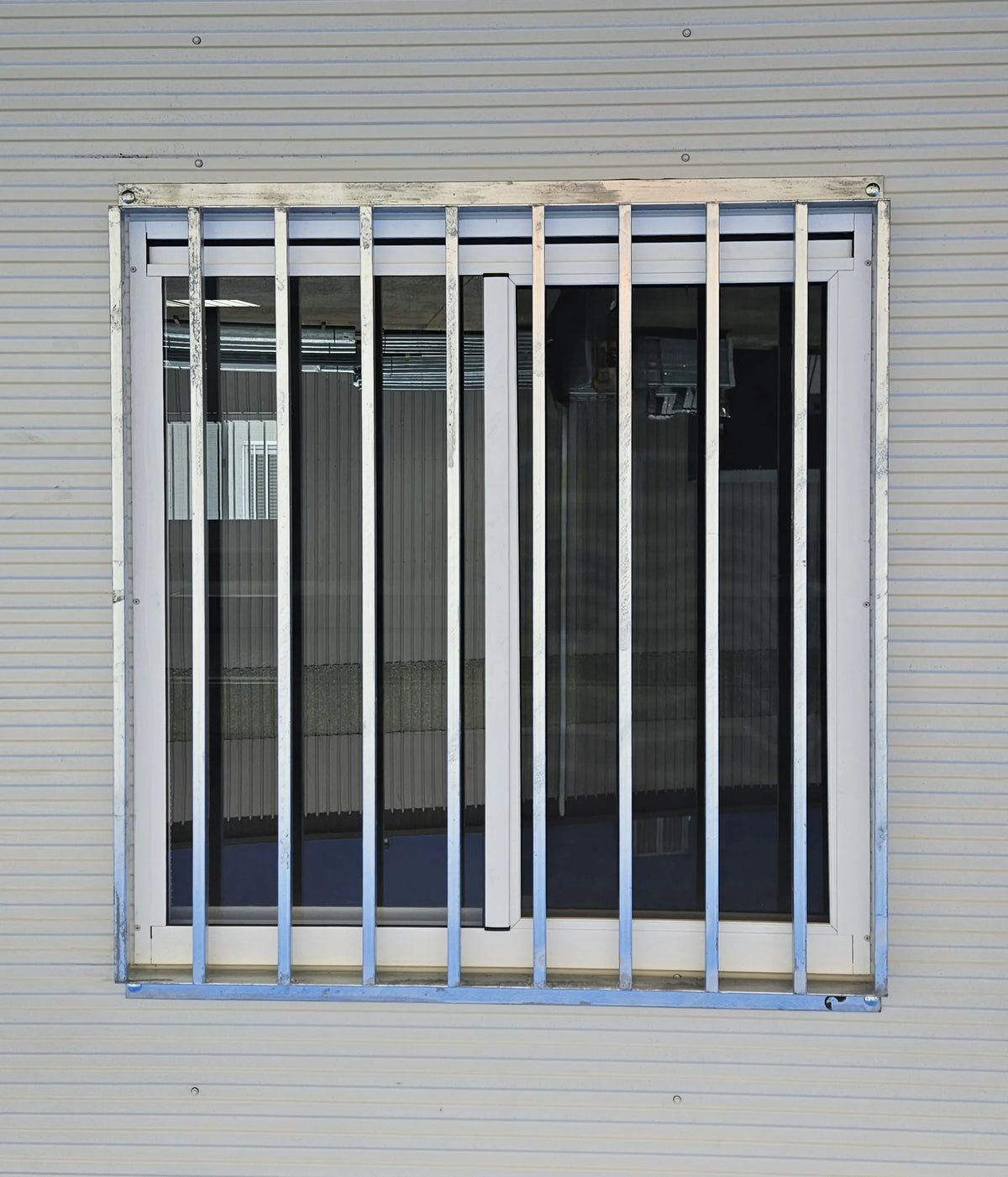RAPTA 1250 x 1260mm galvanised window security grill installed on a modular building